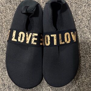 Black Slip-On Shoes with Gold Love Detail